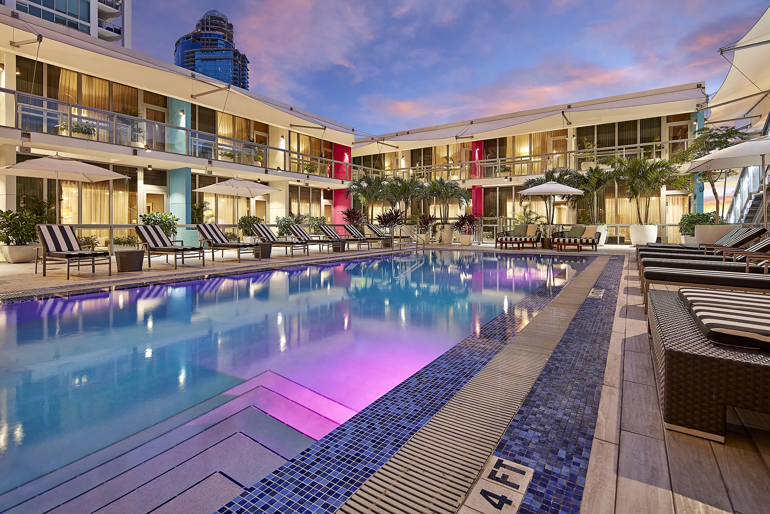 Hotel pool courtyard and surrounding guest-room architecture