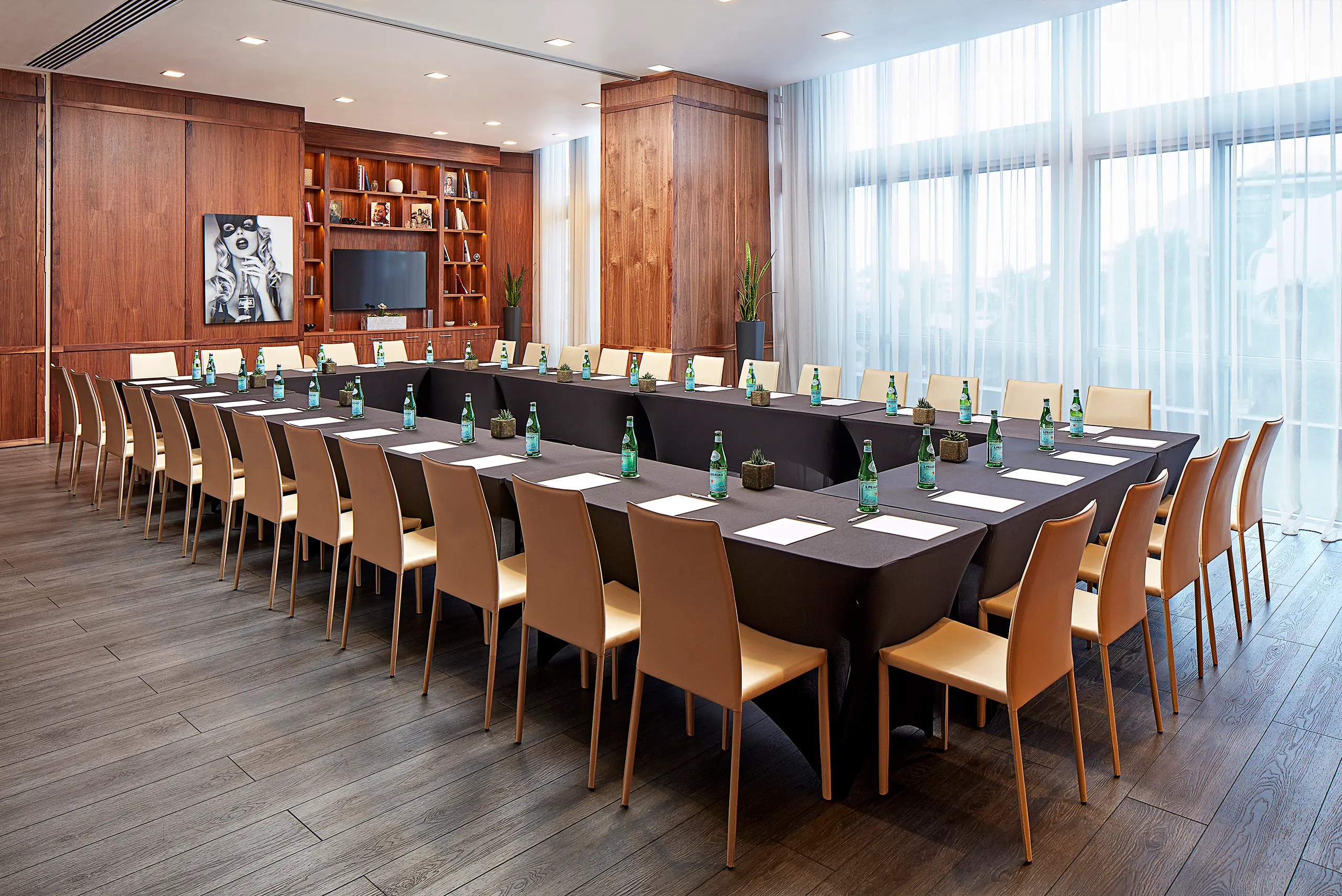 Hospitality meeting room with coordinated woodwork, lighting, flooring, and furnishings