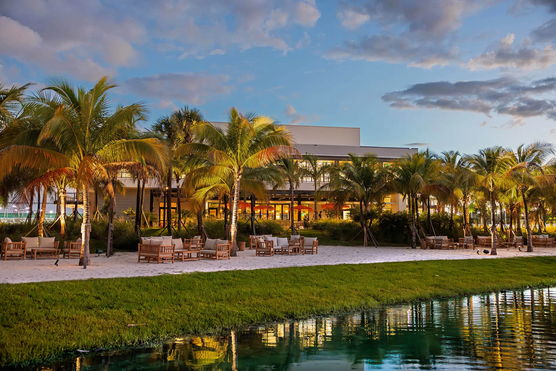 Waterside clubhouse architecture at dusk at The Fort Pickleball