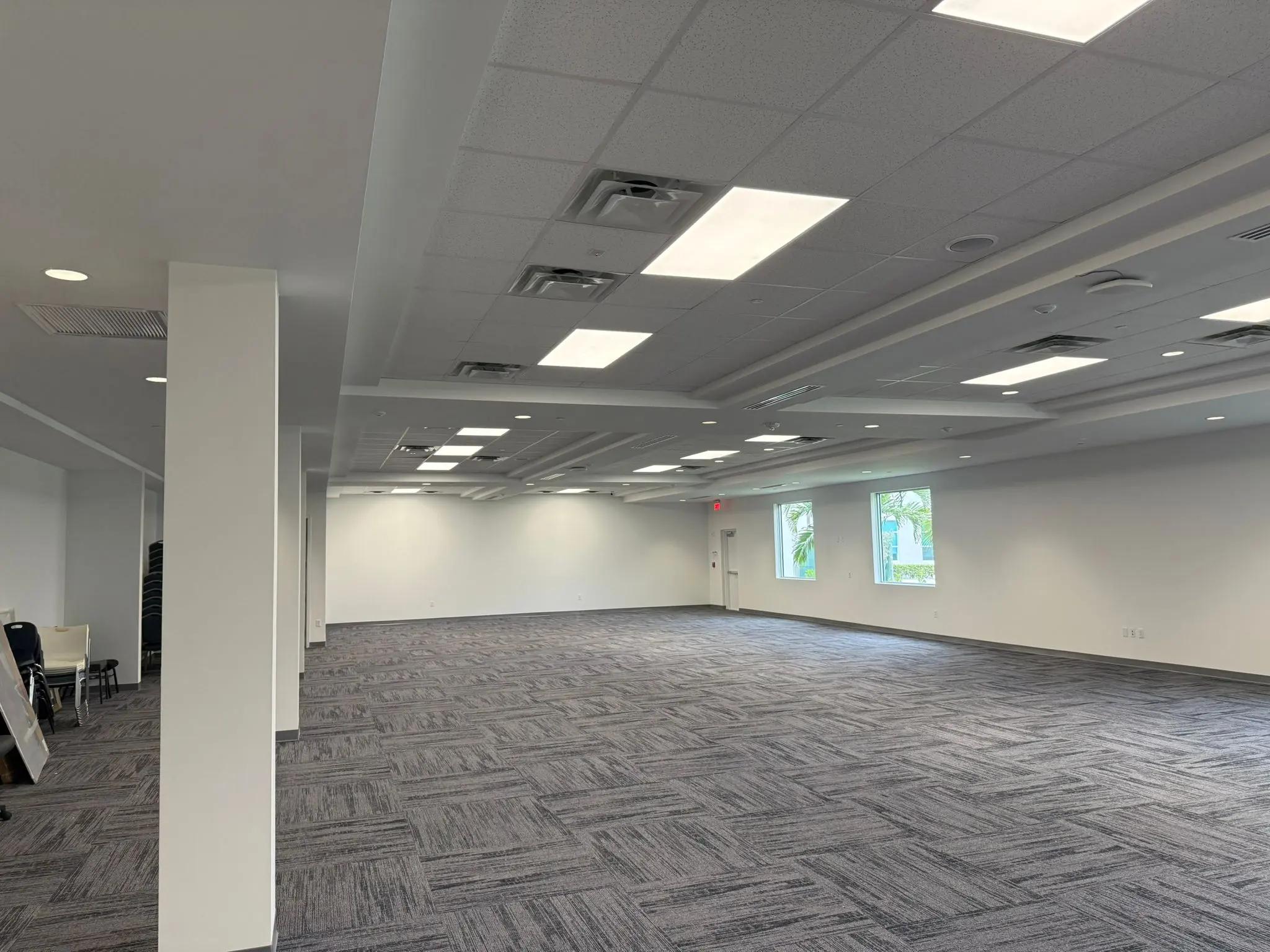 Completed multipurpose room with ceiling systems and carpet installation