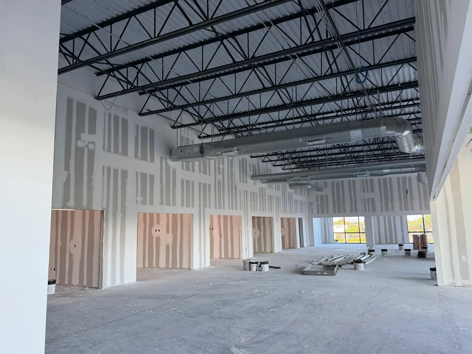 Interior drywall installation with taped joints and finish preparation underway