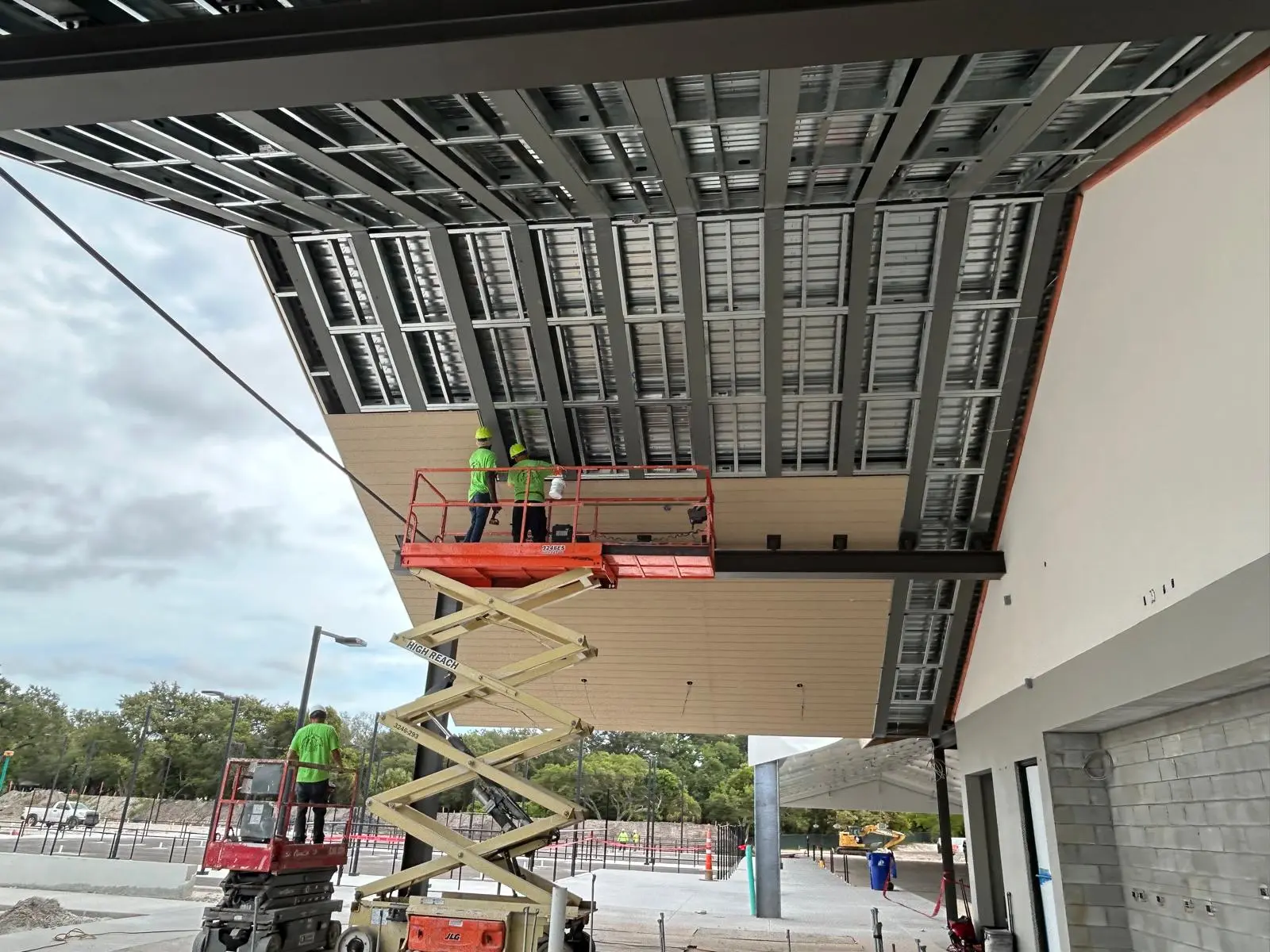 Exterior metal framing installation on a commercial building overhang