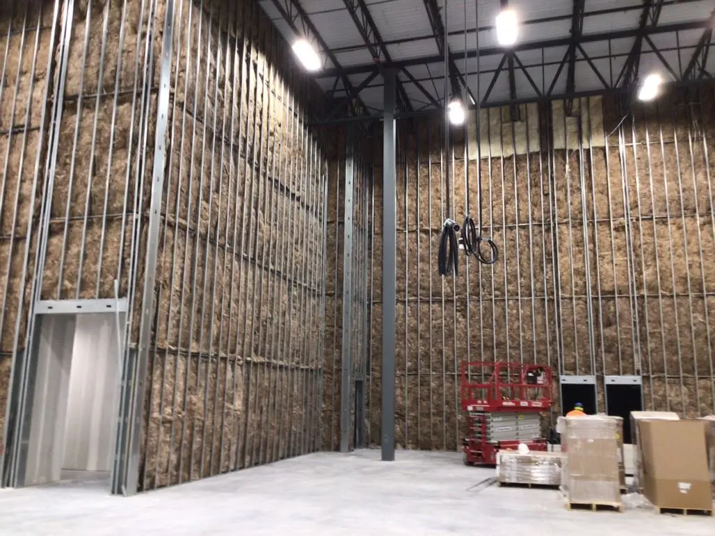 Metal stud wall assemblies prepared for insulation and enclosure