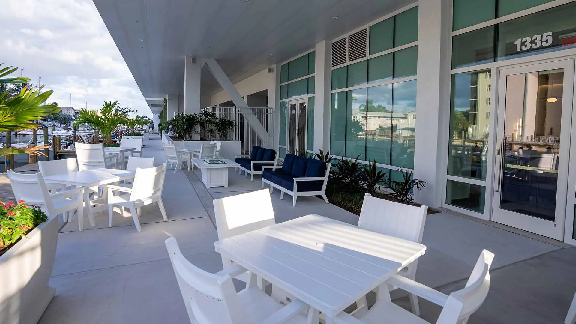 Covered waterfront terrace and glazed facade at F3 Marina