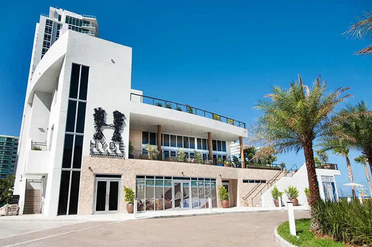 Beach Club exterior with layered facade, glazing, and outdoor circulation