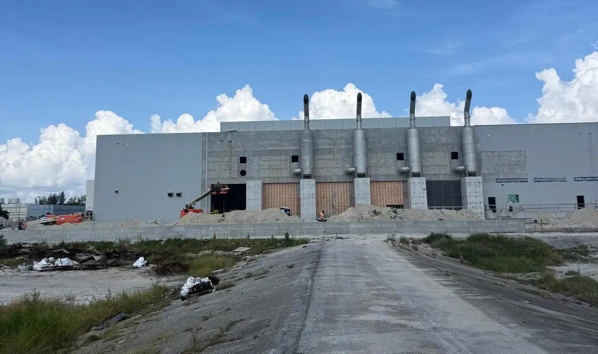 Industrial facility elevation with coordinated envelope, equipment stacks, and site access